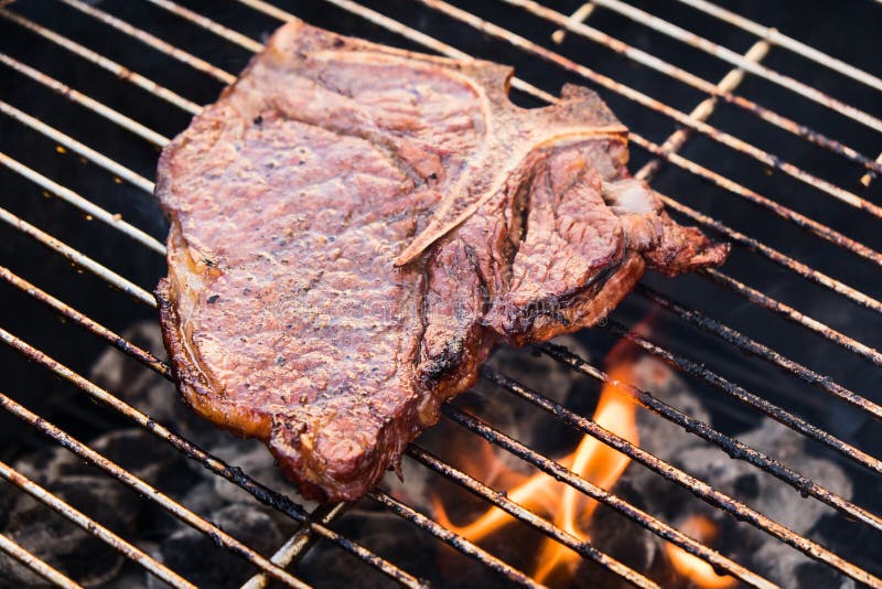 TBone Steak on a Grill stock photo. Image of meat, grill 58811860