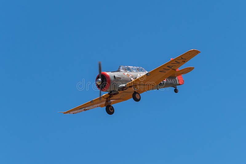 EDEN PRAIRIE, MN - JULY 16, 2016: AT-6 Texan airplane against clear sky with landing gear down at air show. The AT-6 Texan was primarily used as trainer aircraft during and after World War II.