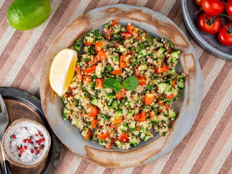 Tabbouleh salad with quinoa. Eastern food with vegetables mix, vegan diet. Top view, linen napkin, old plate royalty free stock images Tabbouleh salad with quinoa. Eastern food with vegetables mix, vegan diet. Top view, linen napkin, old plate royalty free stock images