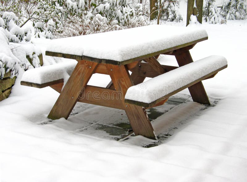 Picnic table covered with snow, on snow-covered terrace. Picnic table covered with snow, on snow-covered terrace