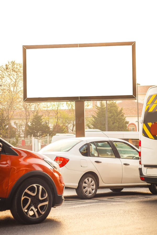 Blank billboard at a frequent highway in downtown of Istanbul. Visual media banner captured at sunset and rush hours with many cars waiting to move. Blank billboard at a frequent highway in downtown of Istanbul. Visual media banner captured at sunset and rush hours with many cars waiting to move.