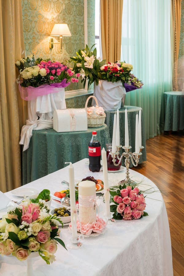 Table of the bride and groom in a restaurant. Decorated for a wedding celebration
