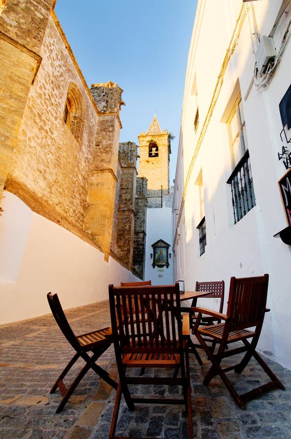 Table and chairs in alley royalty free stock photography