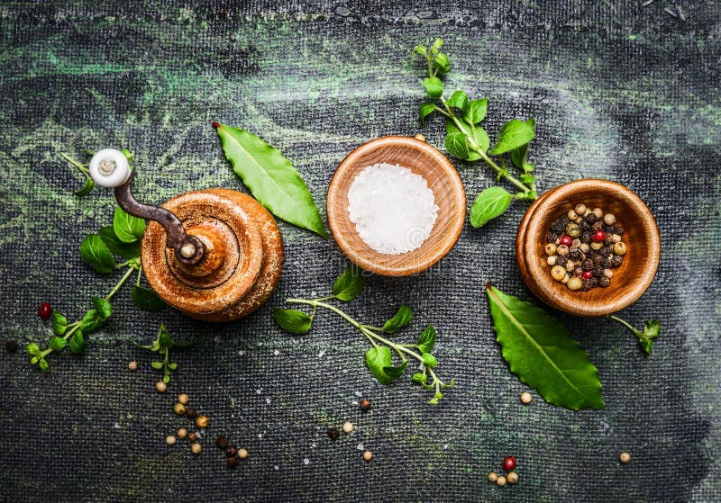 Table or cooking seasoning in wooden bowls on rustic background