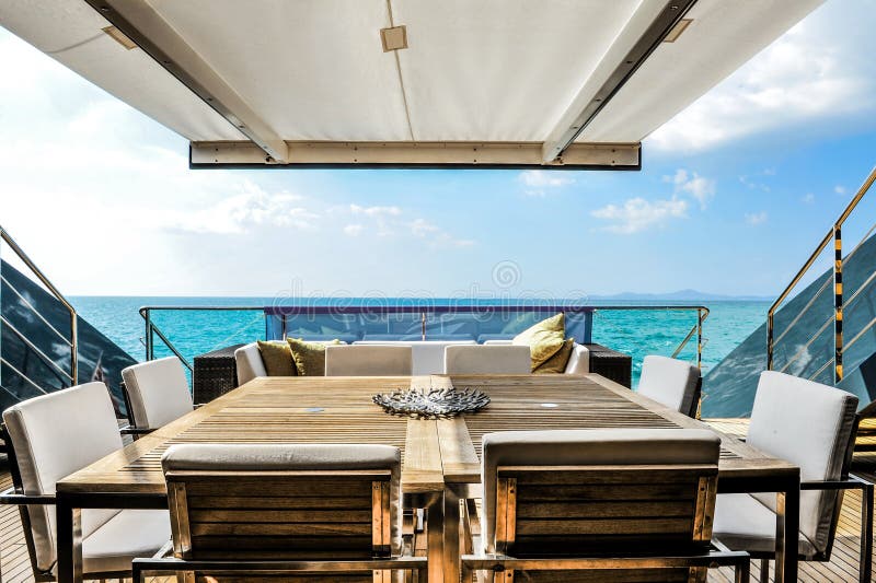 Wooden dining table in yacht. And blue sky. Wooden dining table in yacht. And blue sky.