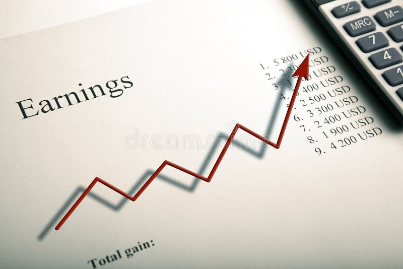 Table with Earnings with Digits, Calculator and Diagram Stock