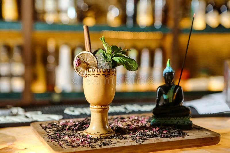 A cup filled with a drink placed on a wooden table. A cup filled with a drink placed on a wooden table.