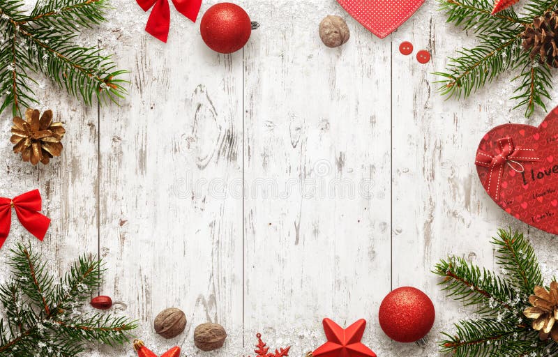 White wooden table with christmas tree and decorations top view. Free space for text. Christmas balls, bow, walnut, pincone, stars and gift beside. White wooden table with christmas tree and decorations top view. Free space for text. Christmas balls, bow, walnut, pincone, stars and gift beside.