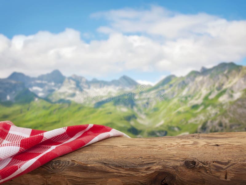 Empty wooden table with red napkins over nature background. Empty wooden table with red napkins over nature background