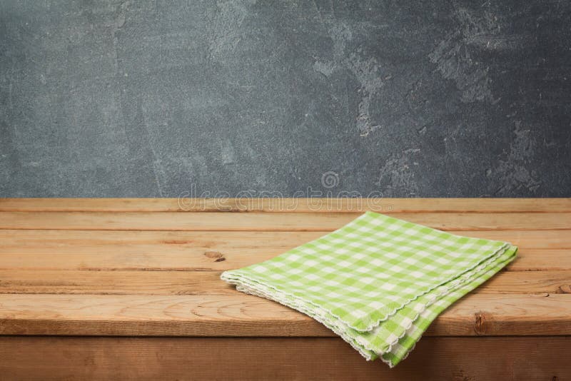 Empty wooden deck table with checked tablecloth over blackboard background for product montage display. Empty wooden deck table with checked tablecloth over blackboard background for product montage display