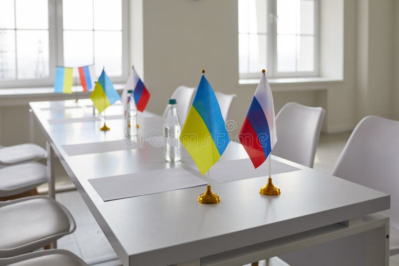 Conference table with flags of Ukraine and Russia in office at start of negotiations aimed to halt shelling and genocide, de-escalate conflict, stop war, restore peace, define strategy on Crimea issue. Conference table with flags of Ukraine and Russia in office at start of negotiations aimed to halt shelling and genocide, de-escalate conflict, stop war, restore peace, define strategy on Crimea issue