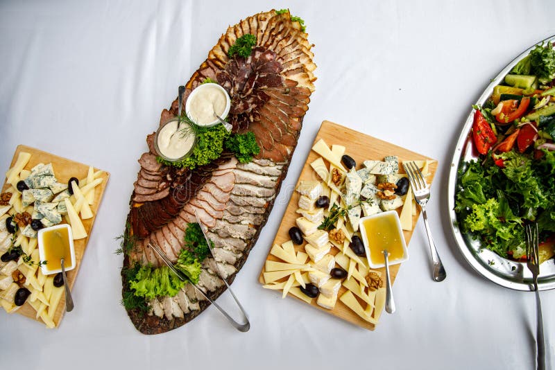 Table Full of Tasty Snacks, Meat, Cheese and Vegetable Plate Stock