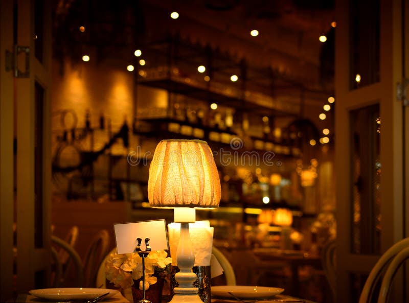 Table lamp in the dining room, blurred background and retro dark bokeh