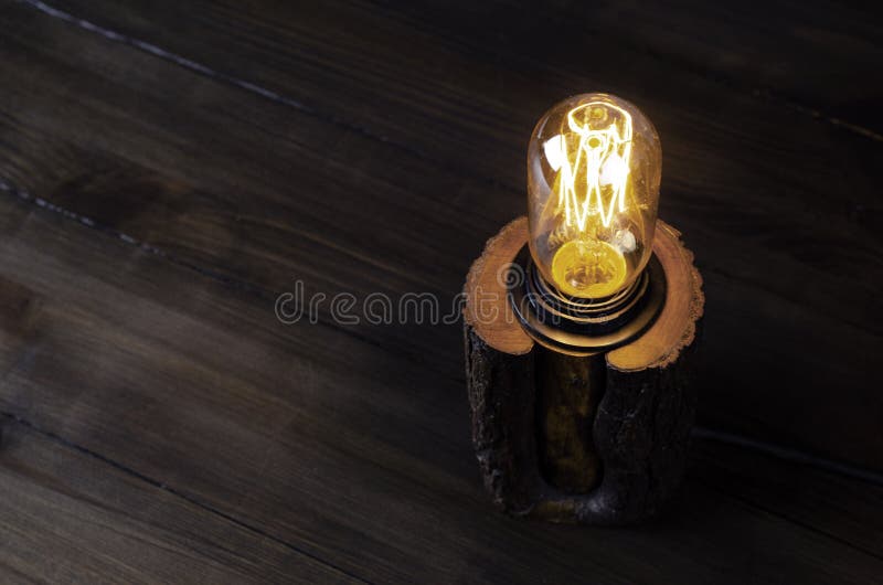 Table lamp. Edison. Light from the lamp. On the table. stock image
