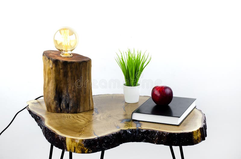 Table lamp. Edison lamp. The book is on the table and an apple. stock photography