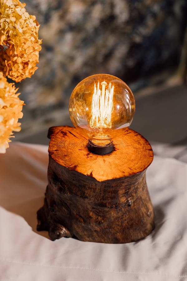 Table lamp made of wood. Edison electric lamp. Incandescent lamp. stock image