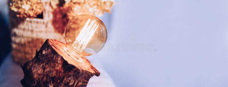 Table lamp made of wood. Edison electric lamp. Incandescent lamp. stock photography