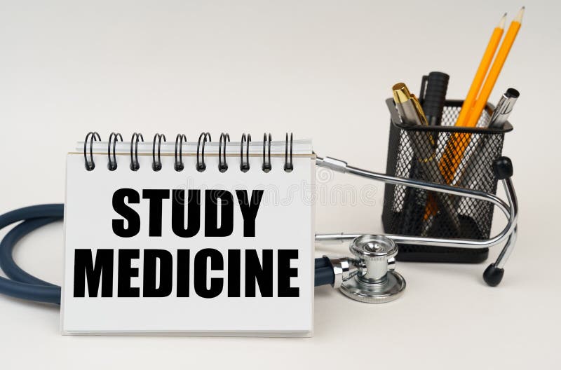 On the Table are Office Supplies, a Stethoscope and a Notepad with the