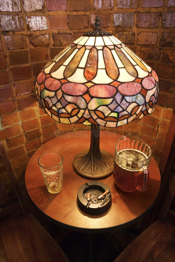 Table with pitcher of beer and cigarette.