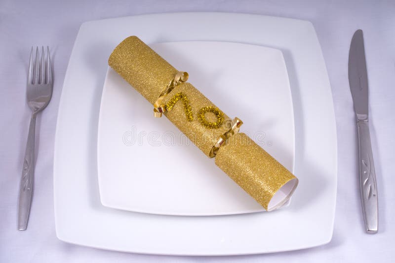 Table Place Setting with a Traditional Cracker for a 70th royalty free stock images