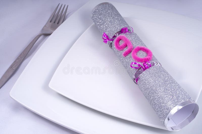 Table Place Setting with a Traditional Cracker for a 90th royalty free stock photography