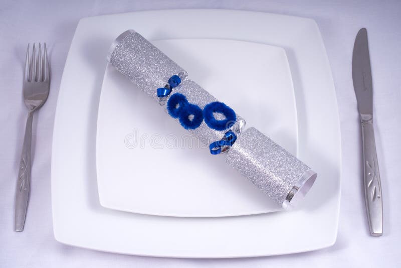 Table Place Setting with a Traditional Cracker for an 80th stock photography