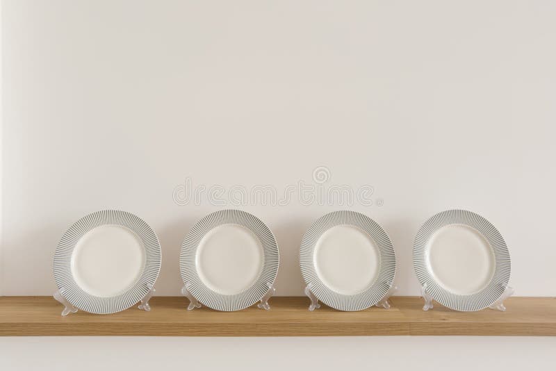 Table Plates on Stands Stand on a Wooden Shelf in the Dining Room Stock