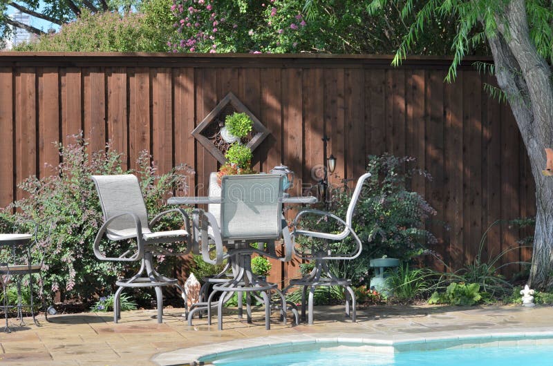 Bartop patio table in beautiful backyard, by the pool. Bartop patio table in beautiful backyard, by the pool.