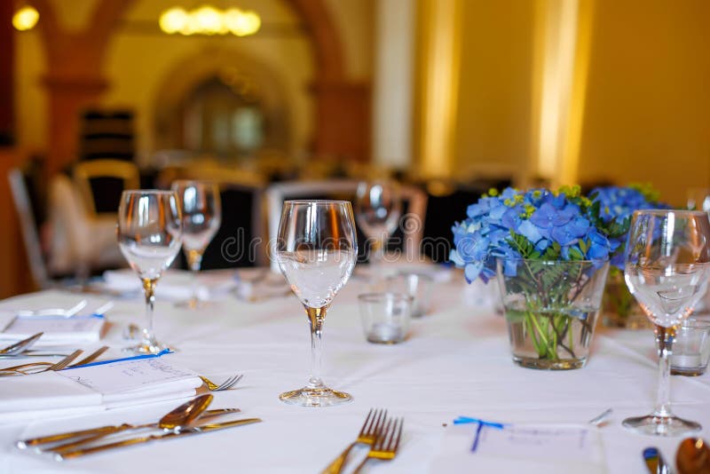 Table set in blue and white for wedding or event party. Luxury decoration for celebration, with give away for guests