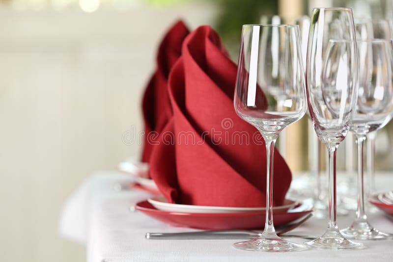 Table setting with empty glasses, plates and cutlery