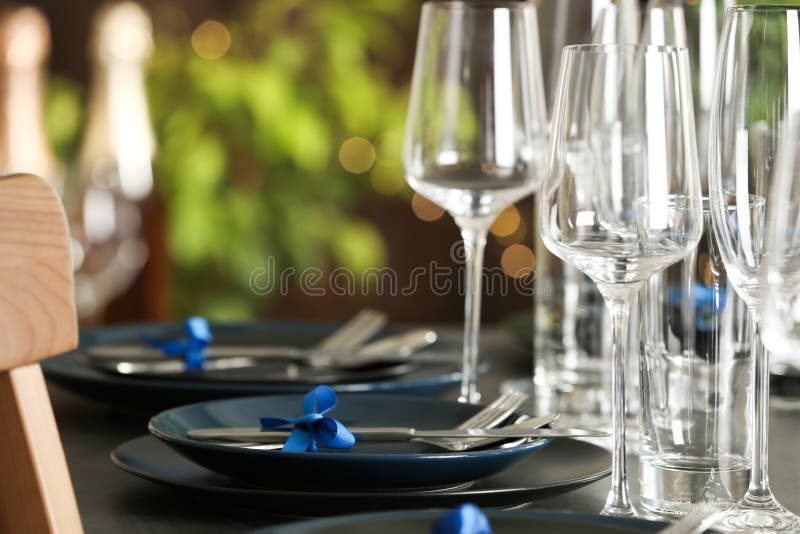 Table setting with empty glasses, plates and cutlery. Space for text