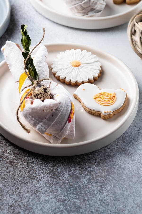 Table setting for the holiday of Easter. The photo shows white dishes, serving mat, Easter egg in a napkin. Napkin royalty free stock images Table setting for the holiday of Easter. The photo shows white dishes, serving mat, Easter egg in a napkin. Napkin royalty free stock images