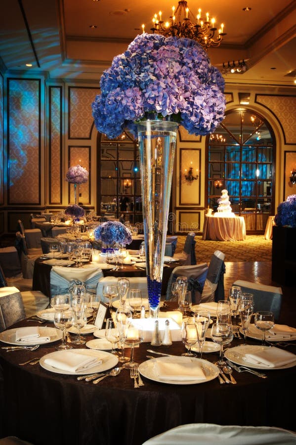 An image of a Table setting at a luxury wedding reception in a large ballroom