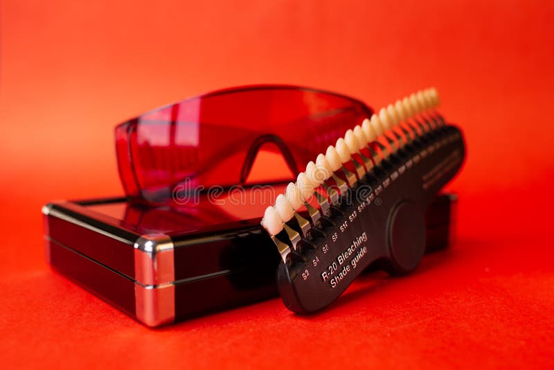 Table of Teeth Color. Scale on a Red Background Closeup Stock Image