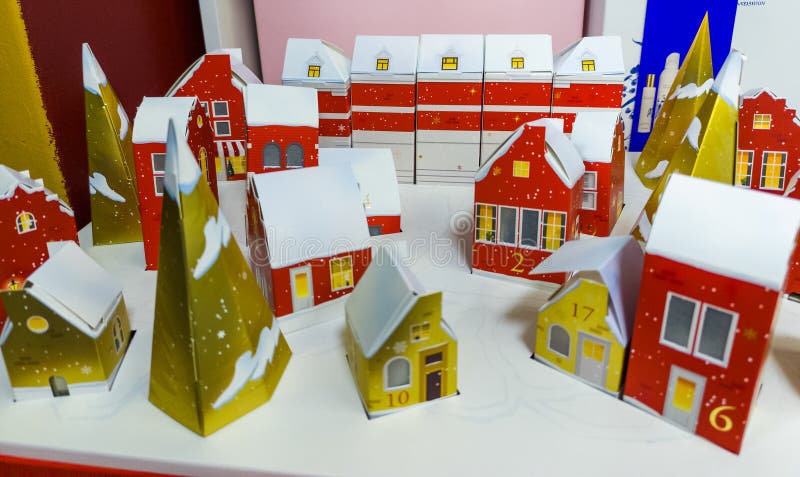 A table topped with lots of paper houses covered in snow stock images