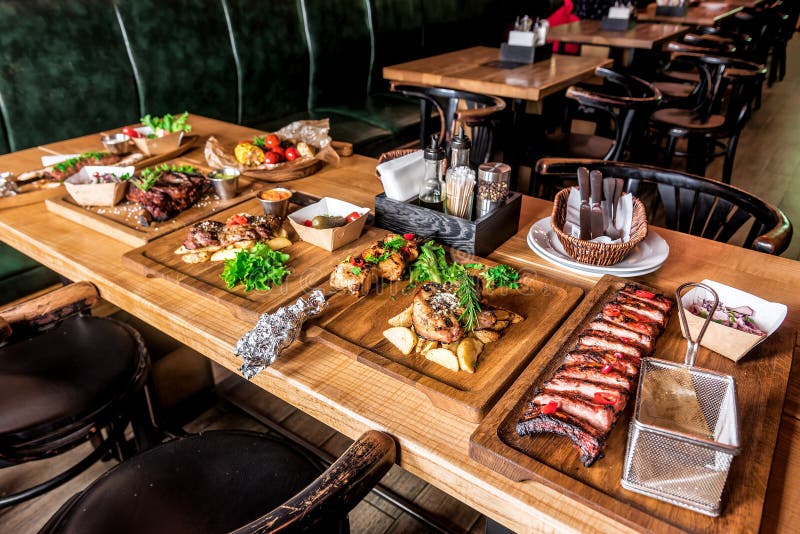 Table with various meat dishes stock photo