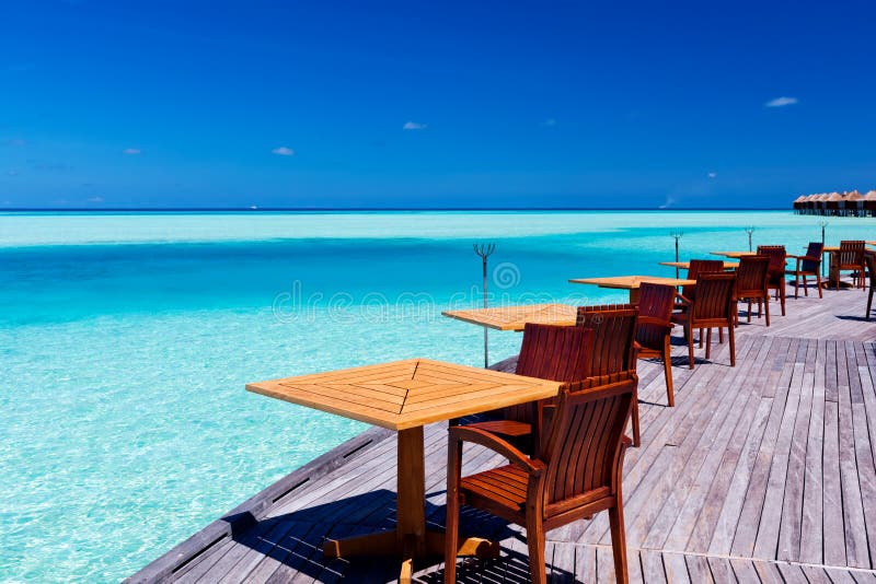 Tables and chairs at tropical beach restaurant stock photos Tables and chairs at tropical beach restaurant stock photos