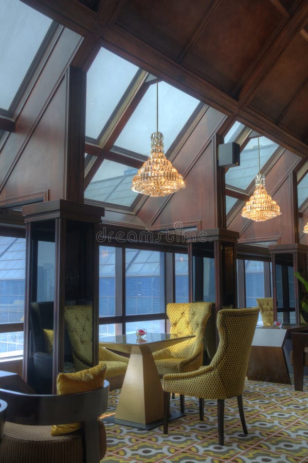 Tables and Lounge Chairs with Hanging Lights in a Comfortable Lounge