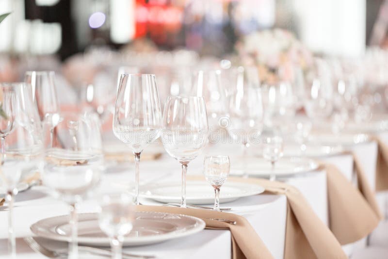 Tables set for an event party or wedding reception. luxury elegant table setting dinner in a restaurant. glasses and stock photo Tables set for an event party or wedding reception. luxury elegant table setting dinner in a restaurant. glasses and stock photo