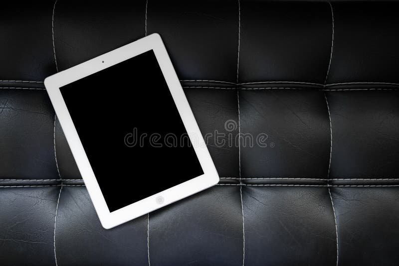 Tablet on black sofa