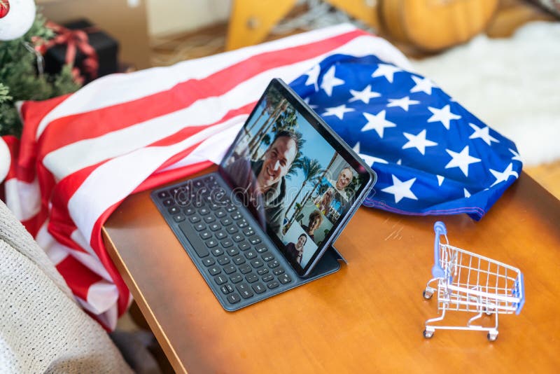 Tablet pc computer on american flag, technology, patriotism, anniversary, national holidays and independence day.