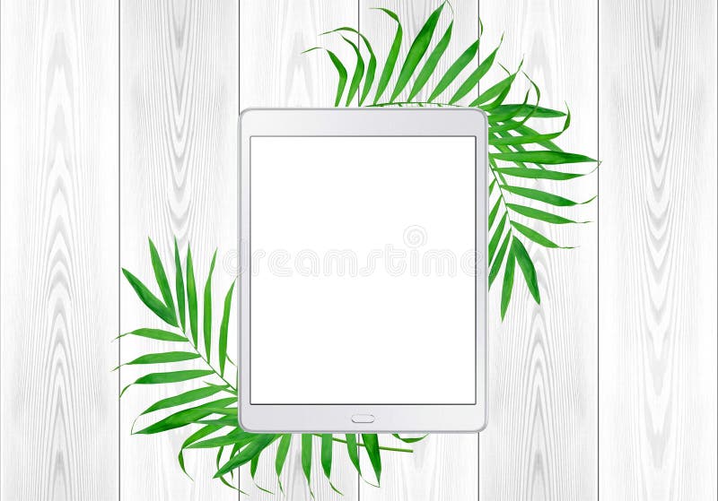 Tablet Pc In Green Fern Leaves Frame On White Wood Table