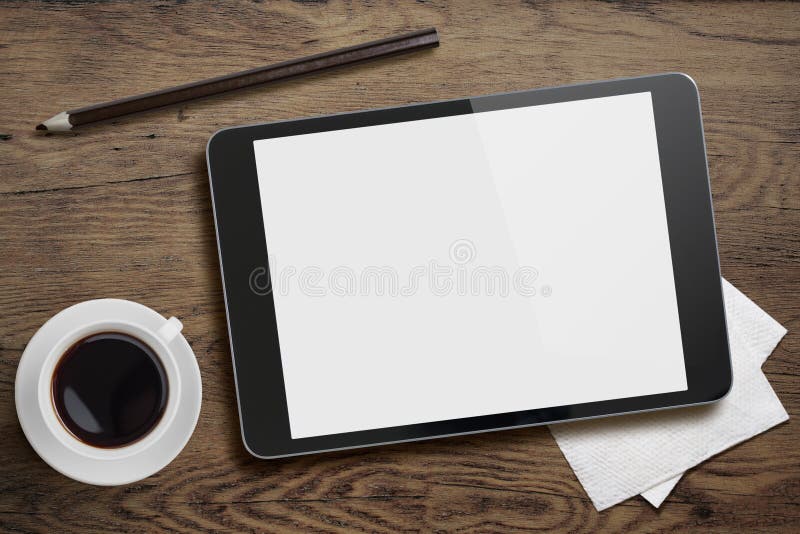 Tablet pc on table desk with coffee cup and pencil