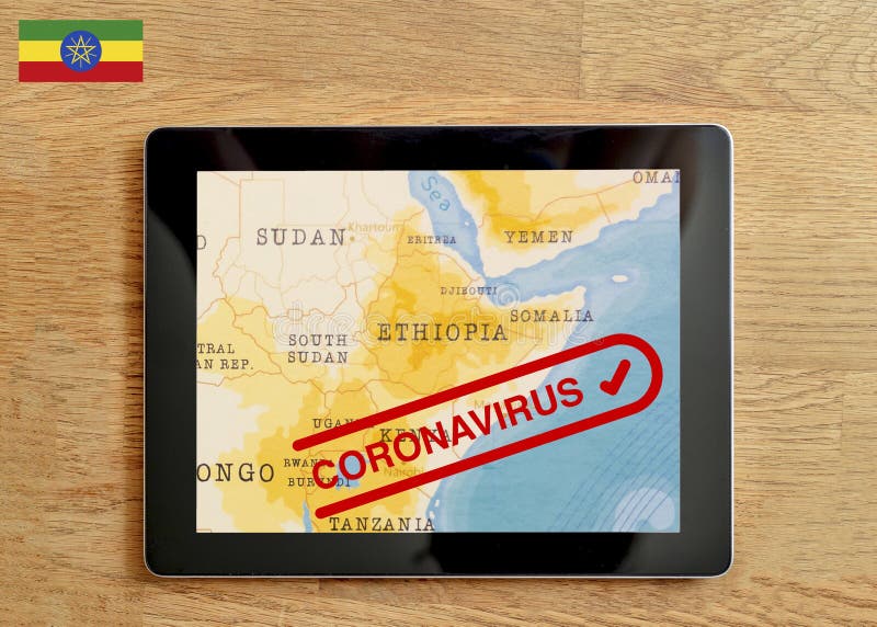 A Tablet PC which is displayed with map of Ethiopia and Coronavirus text on the wooden table. royalty free stock photography
