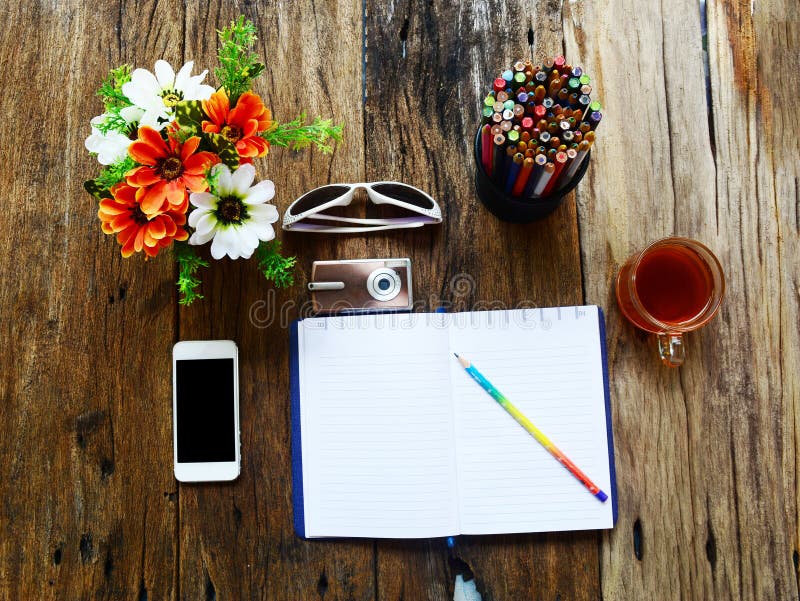 tablet ,phone camera ,eyeglasses,an opened notebook