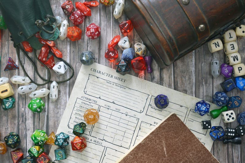 Tabletop roleplaying flat lay with colorful RPG and game dices,  character sheet, rule book and treasure chest