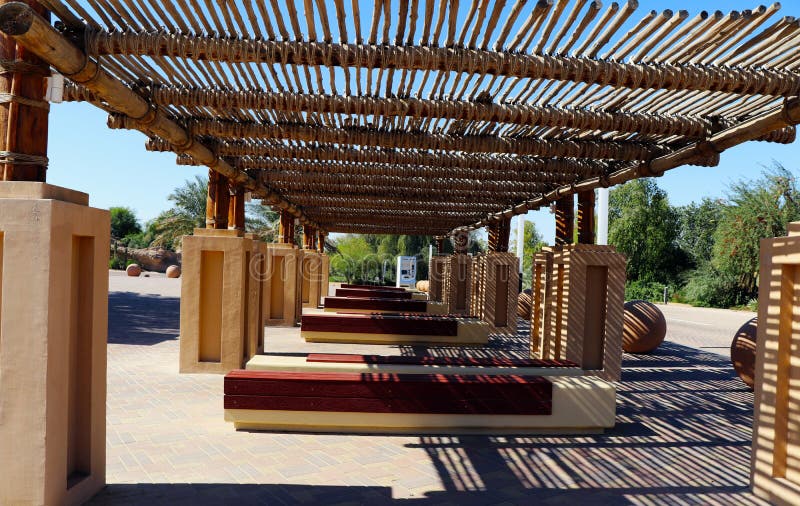 Array of a wooden benches under pergolas on sunny bright day. Array of a wooden benches under pergolas on sunny bright day