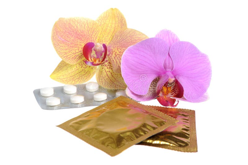 tabuletas e preservativos Filme-revestidos com as duas flores da orquídea isoladas