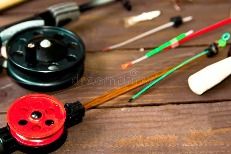 Tackle for winter fishing. Fishing rods and accessories on a wooden table. The view from the top royalty free stock photography Tackle for winter fishing. Fishing rods and accessories on a wooden table. The view from the top royalty free stock photography