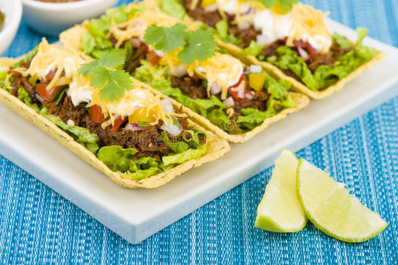 Beef Tacos - Shredded beef taco trays topped with salsa, sour cream and grated cheese. Beef Tacos - Shredded beef taco trays topped with salsa, sour cream and grated cheese.